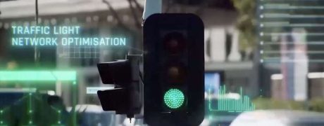 Traffic light with a glowing green signal and holographic text 'TRAFFIC LIGHT NETWORK OPTIMISATION' in the foreground.